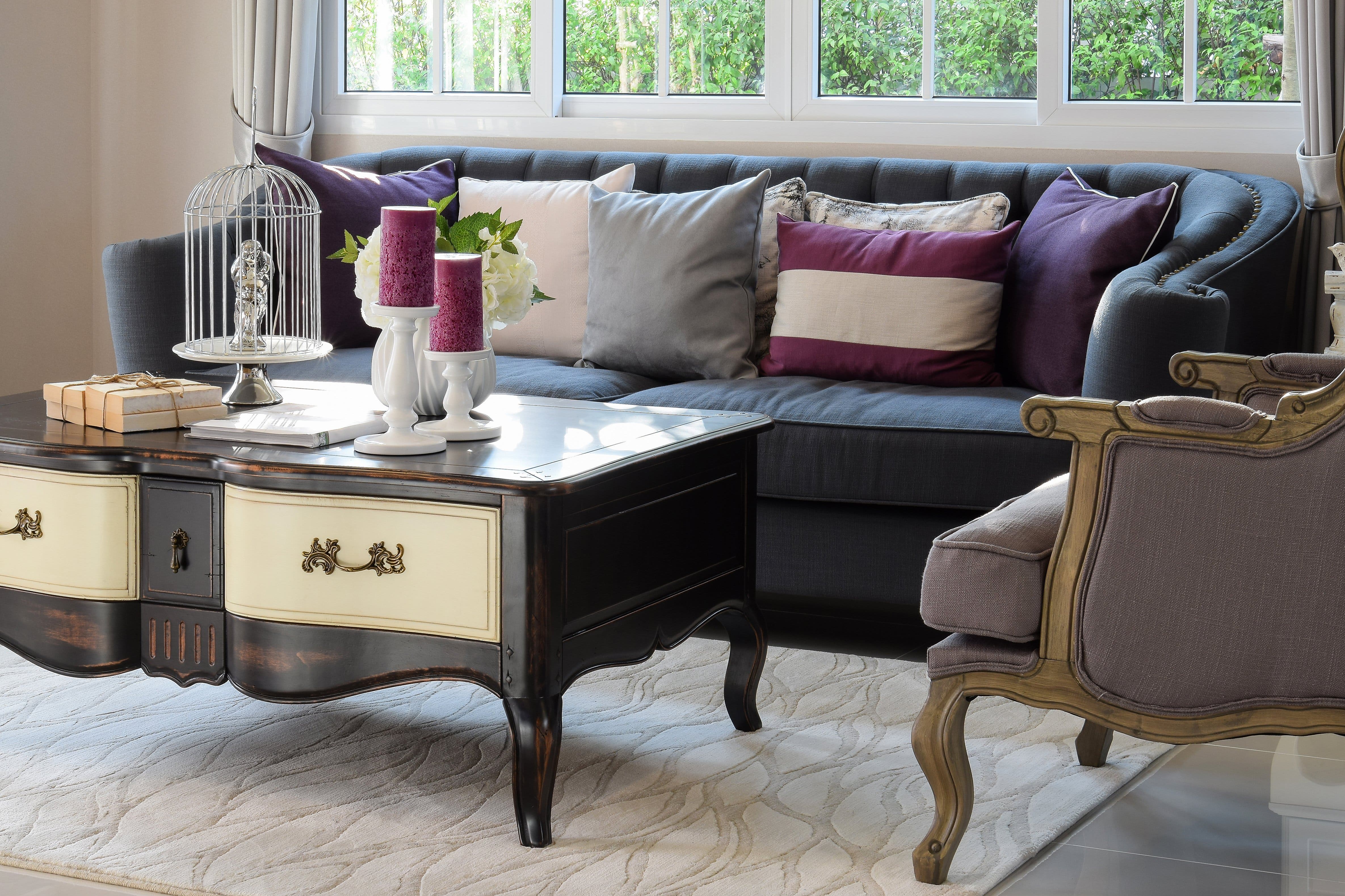 Living area with ultra-violet touches in throw pillows and candles. 