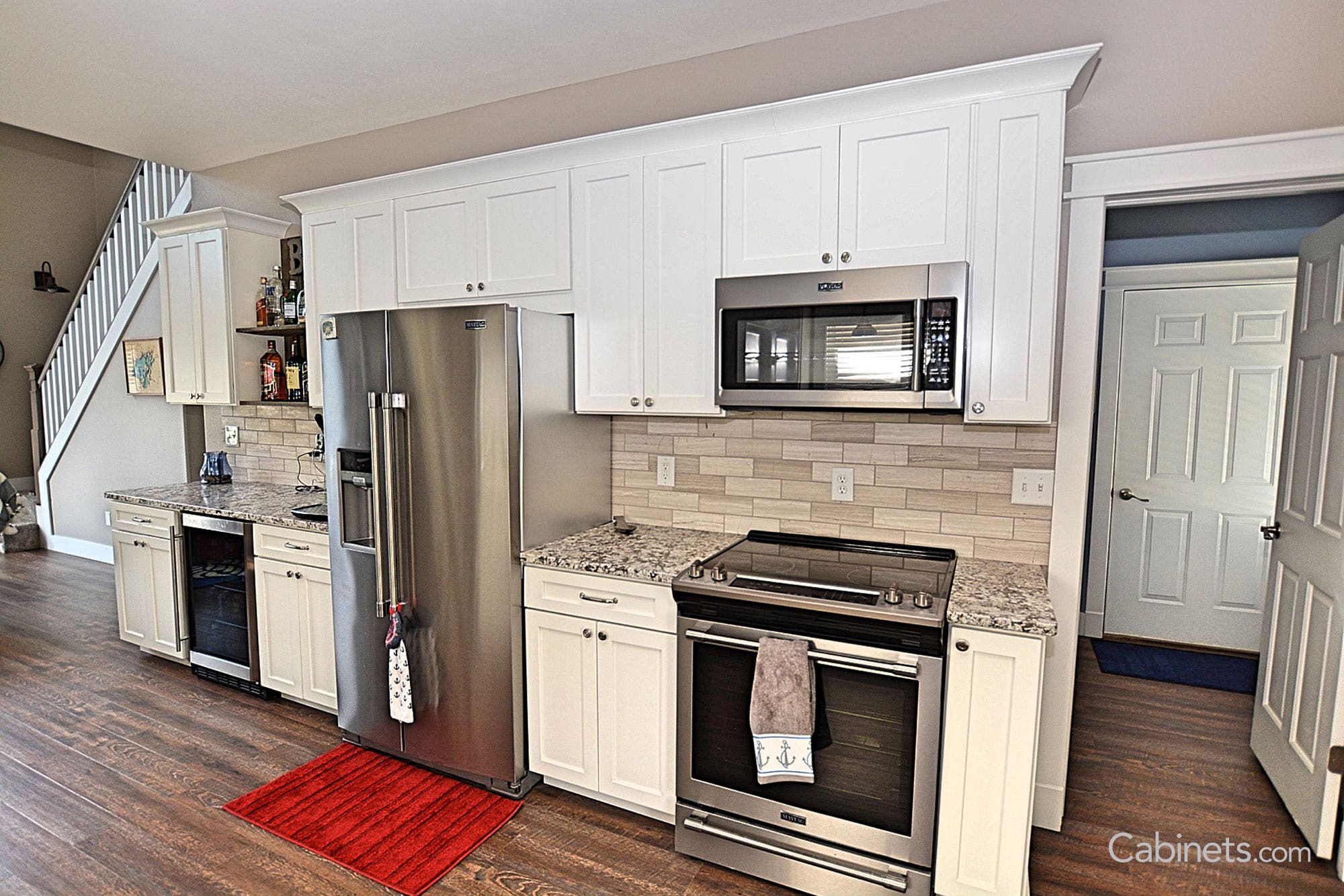 Colonial II Maple Bright White cabinetry with stainless appliances