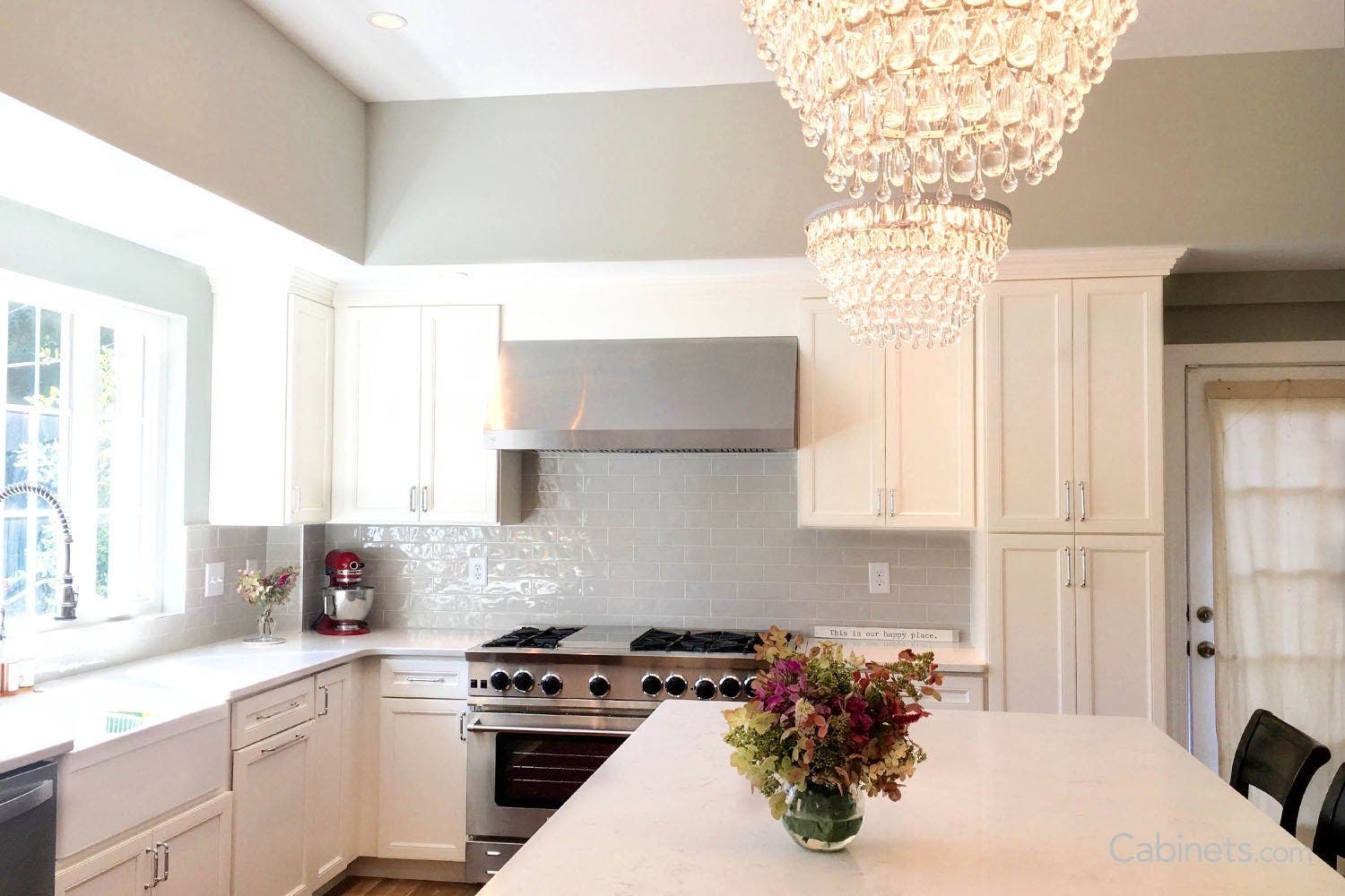 Two crystal chandeliers over bright white isalnd