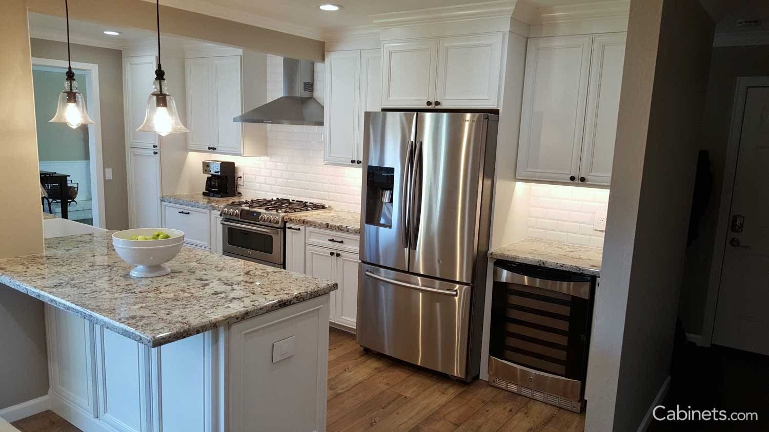 The beveled white subway tile pairs perfectly with the granite top. It provides a clean backdrop for the busier stone countertop.