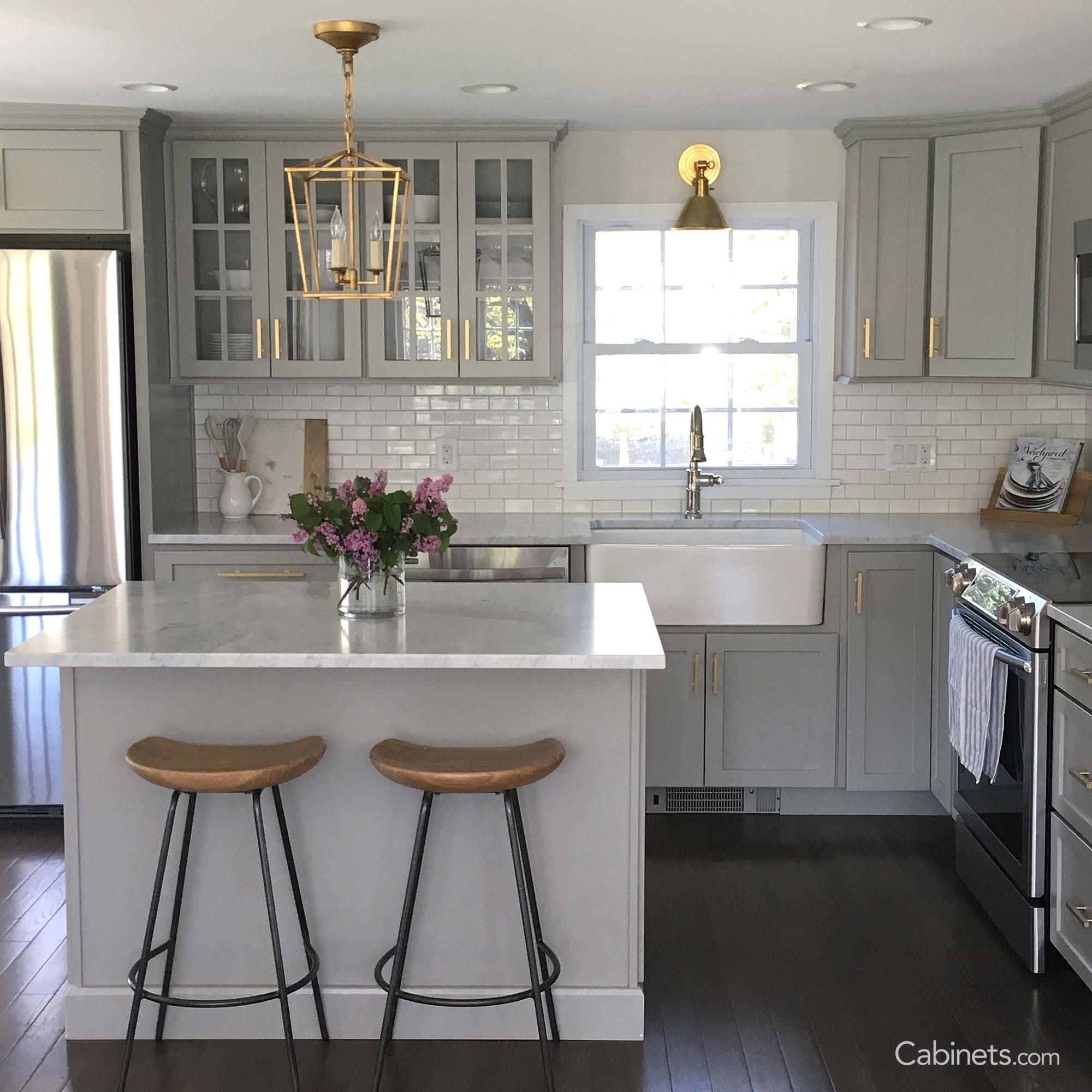 Willow grey cabinets with gold hardware and a white farmhouse sink