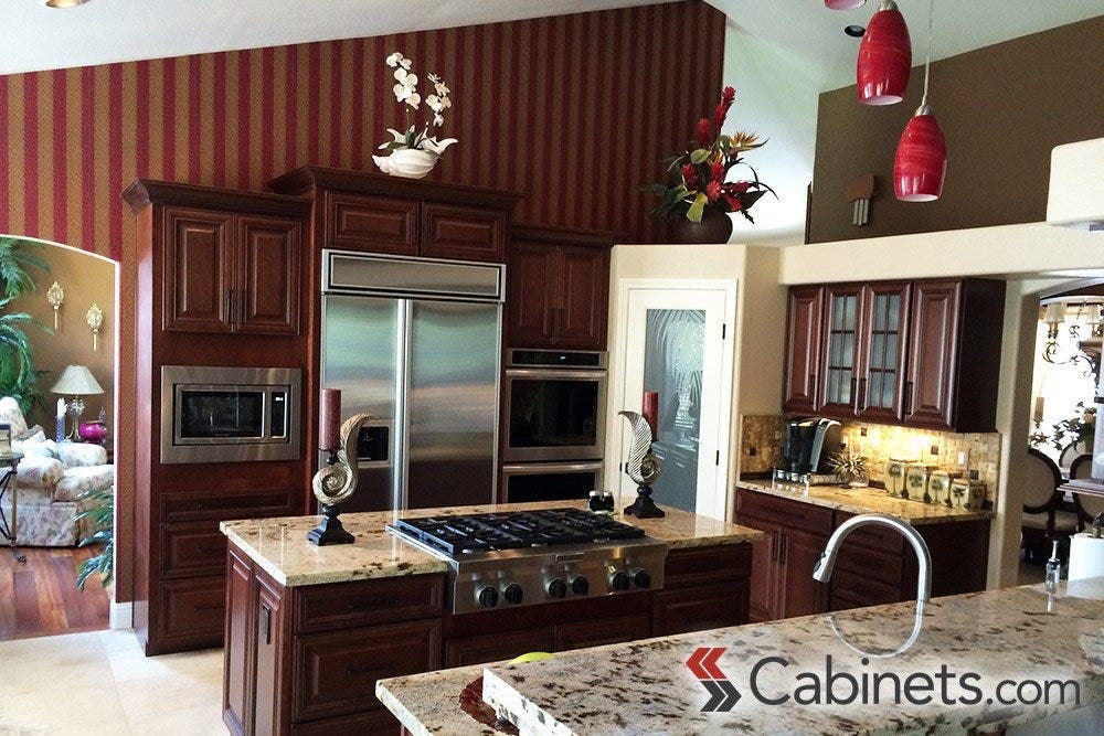 A traditionally styled kitchen with granite countertops.