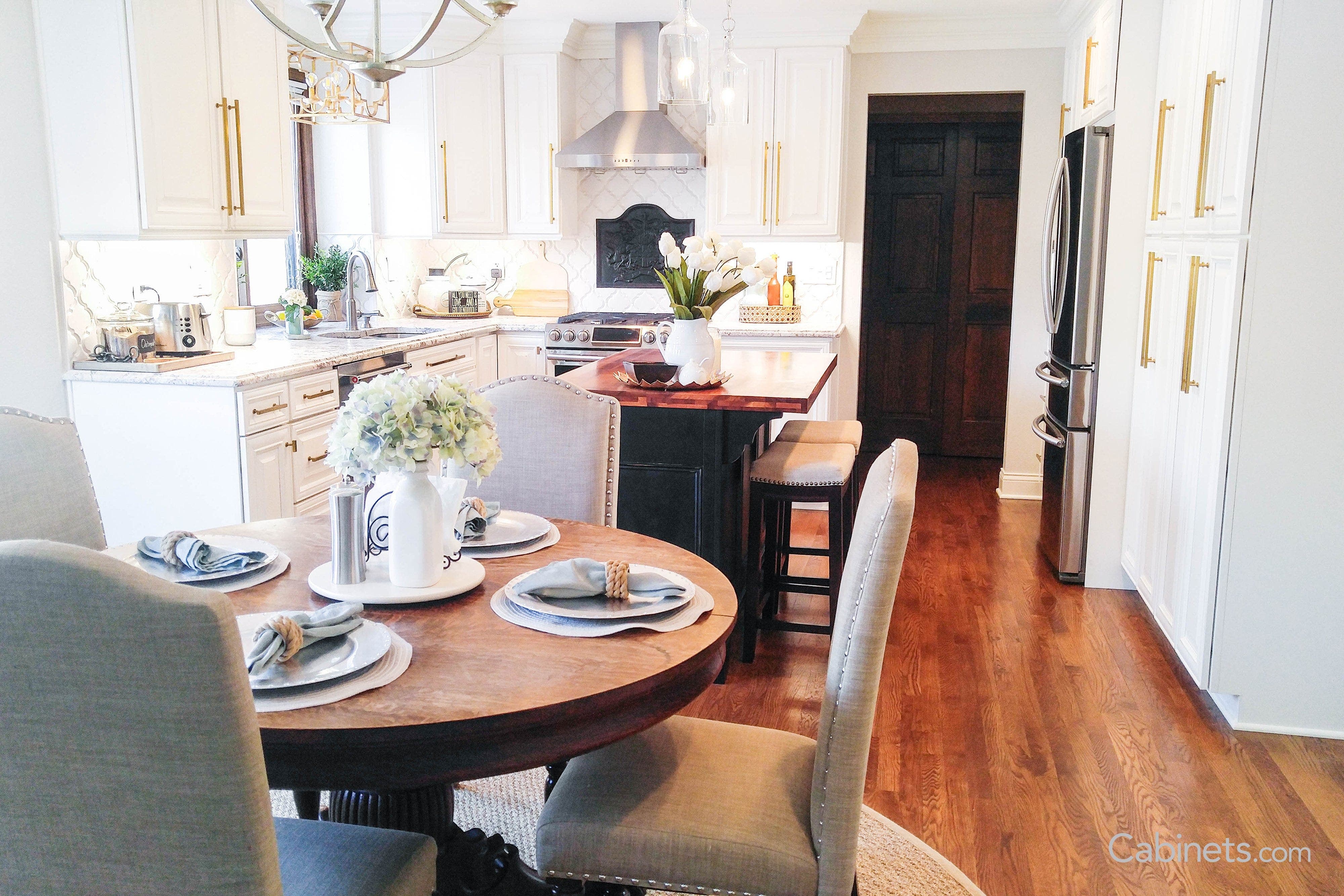 White kitchen decorated with natural plants and flowers