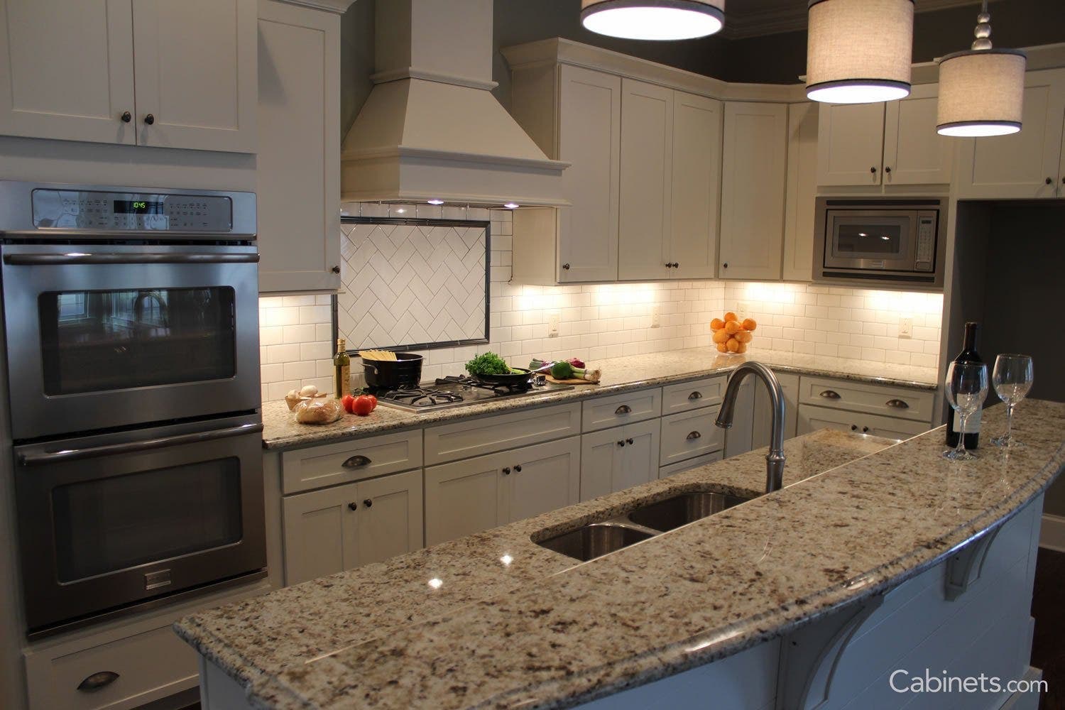 Here\'s an example of a lighter countertop paired with white cabinets, giving the kitchen a lighter, brighter feel.