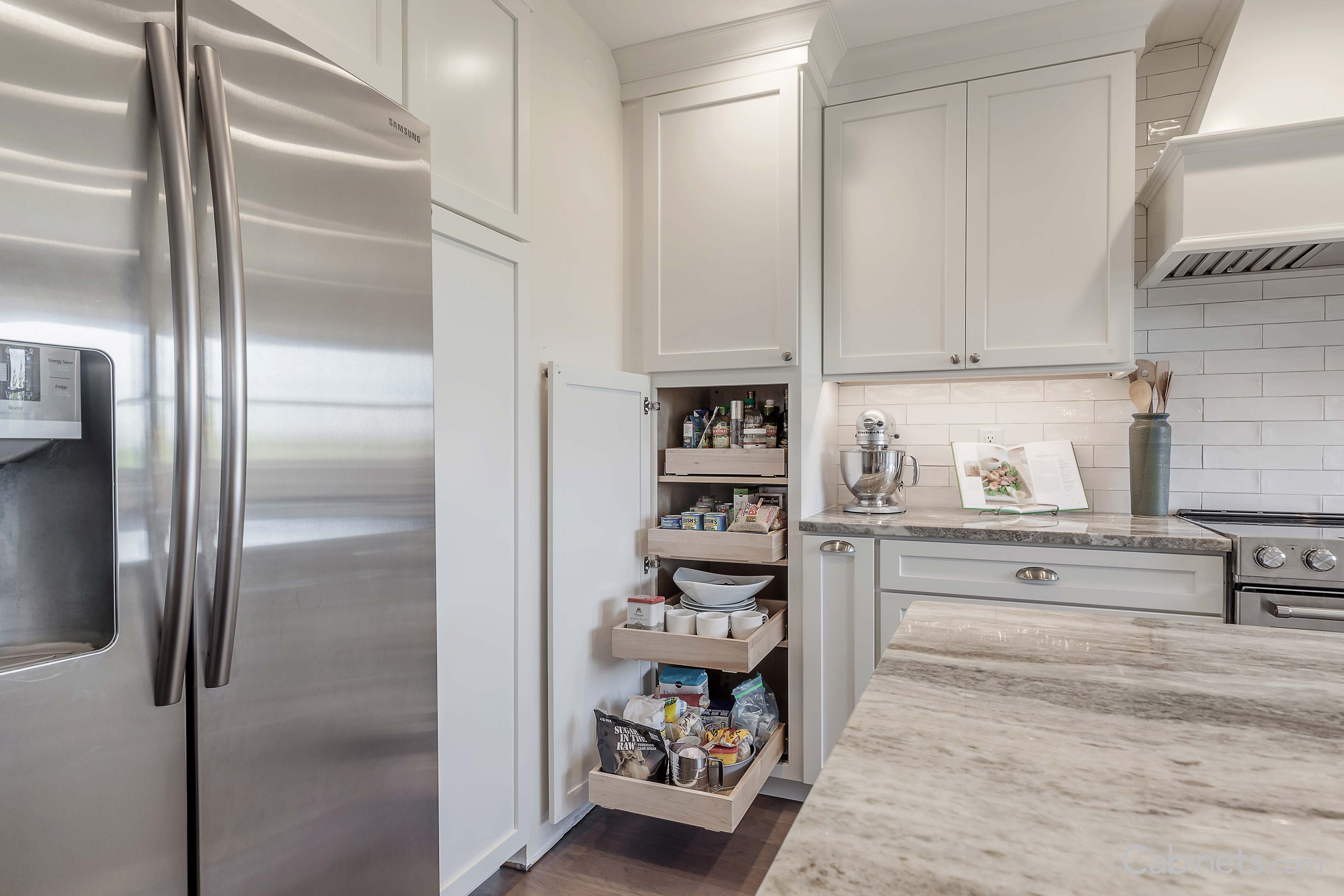 White cabinets with pull out trays in pantry