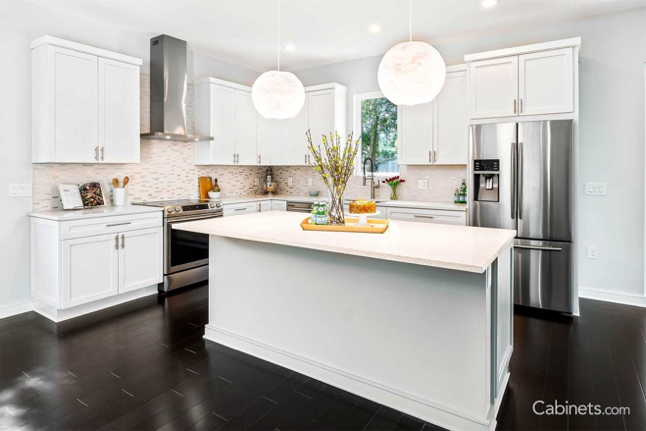 Bright white modern kitchen with large, simple pendant lighting