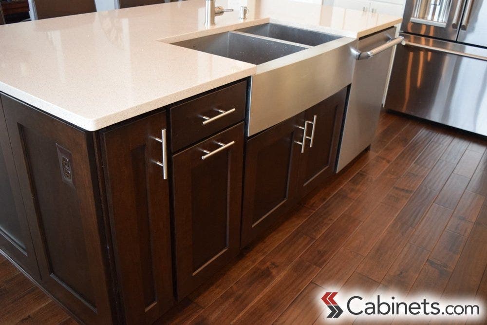 A modern application of espresso stained cabinets...the simple hardware and clean white countertops are the perfect choices to go with this style.