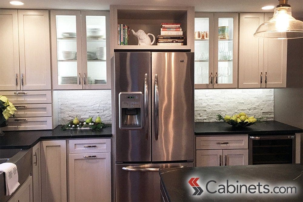 The glass display cabinets flanking the refrigerator add just the right amount of display space for this customer.