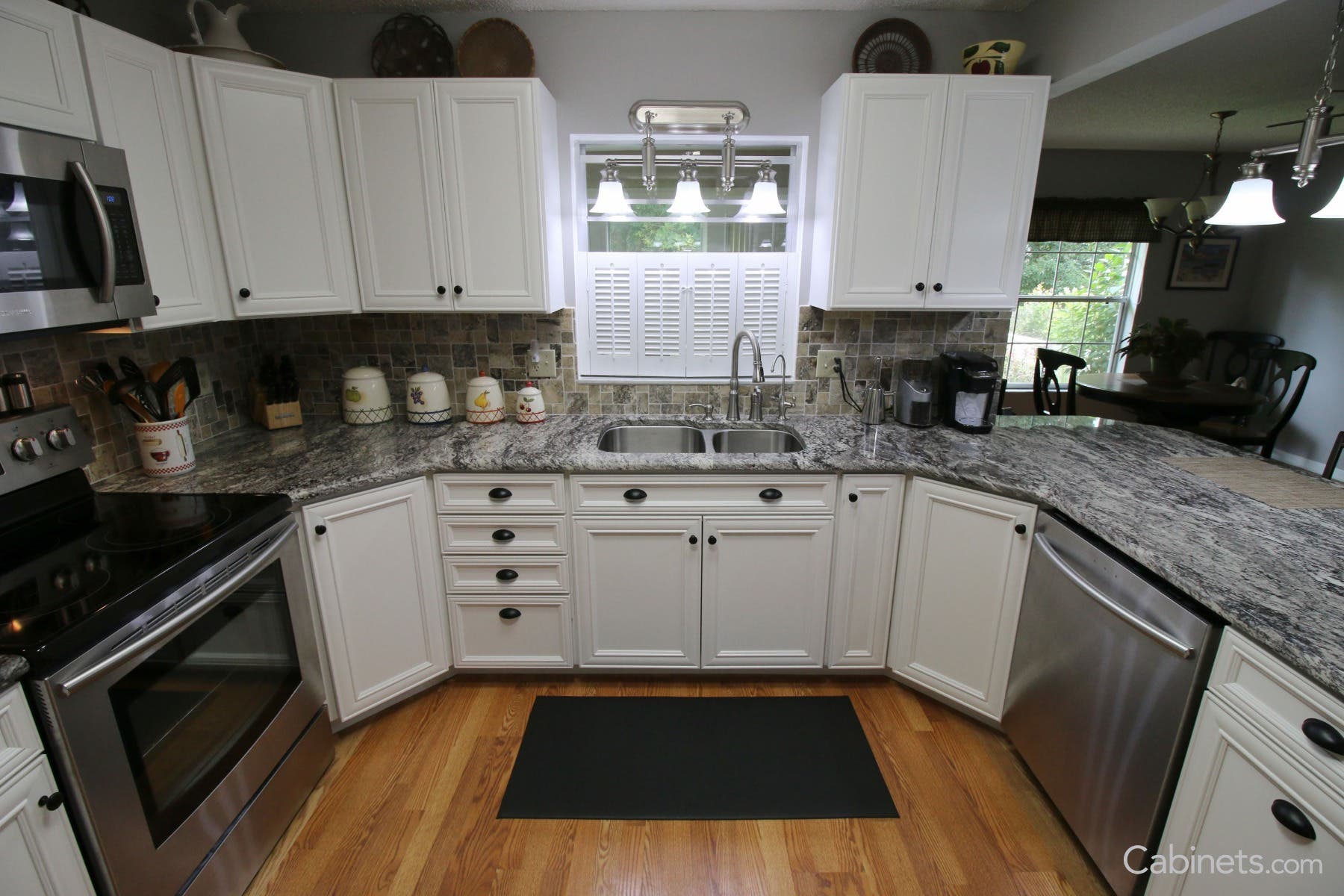 White cabinets with combination of black knobs and cups